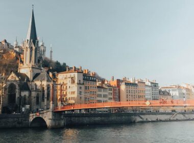brown concrete building near river during daytime
