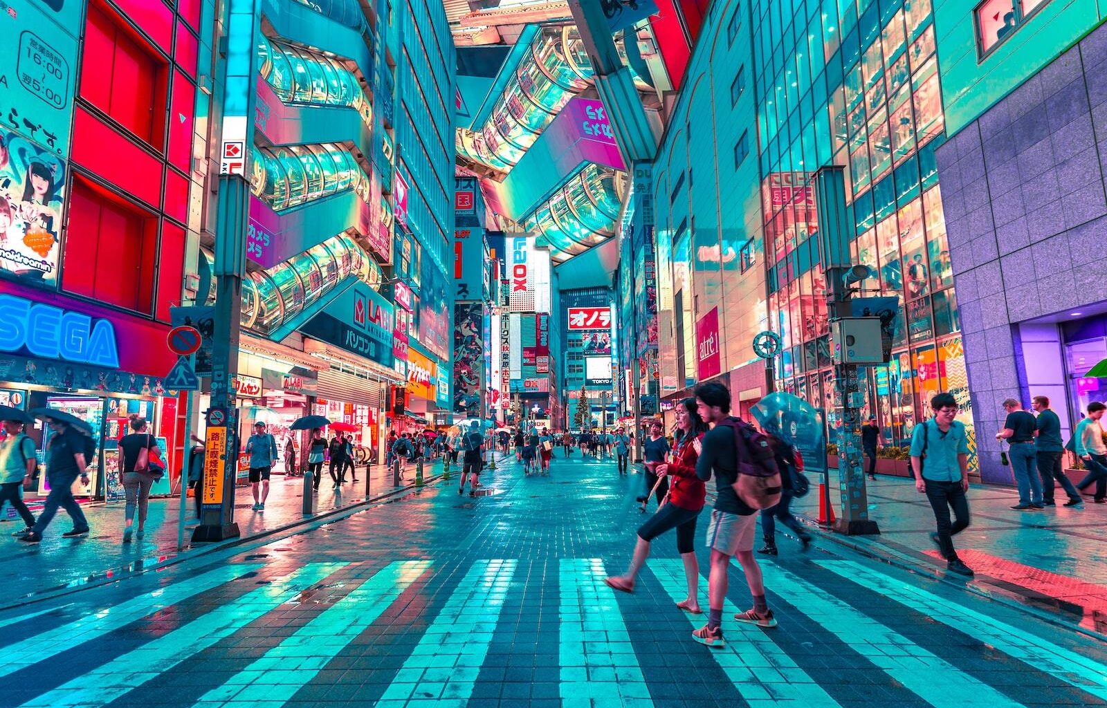people walking on road near well-lit buildings