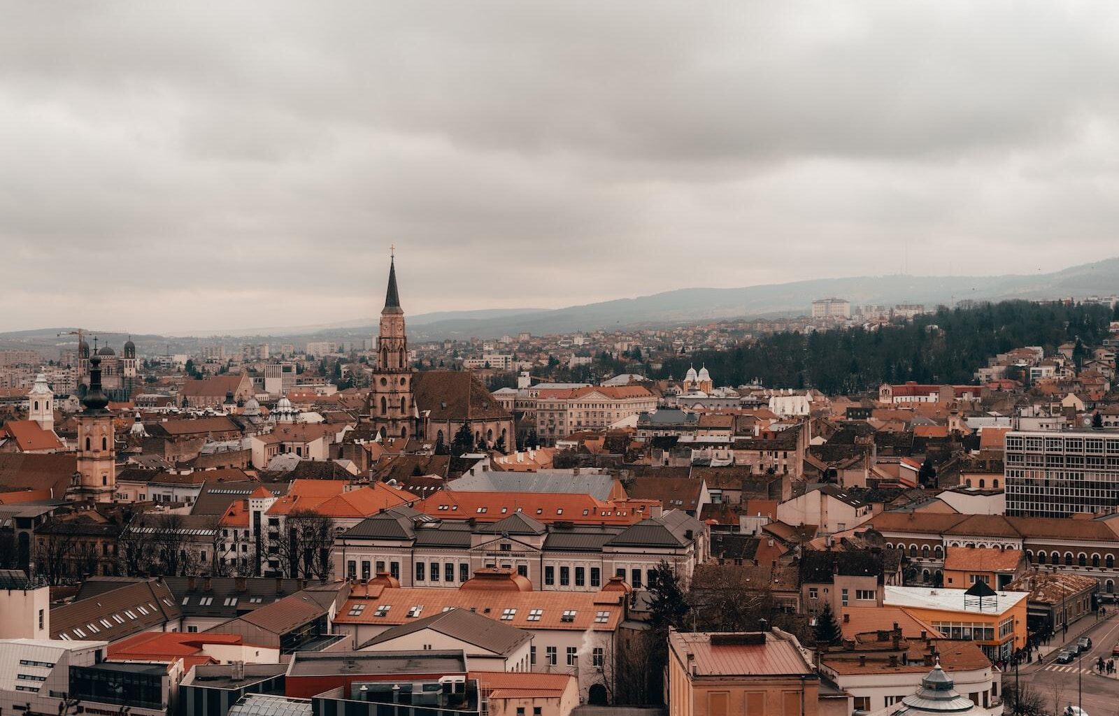 brown and white concrete houses under white clouds during daytime