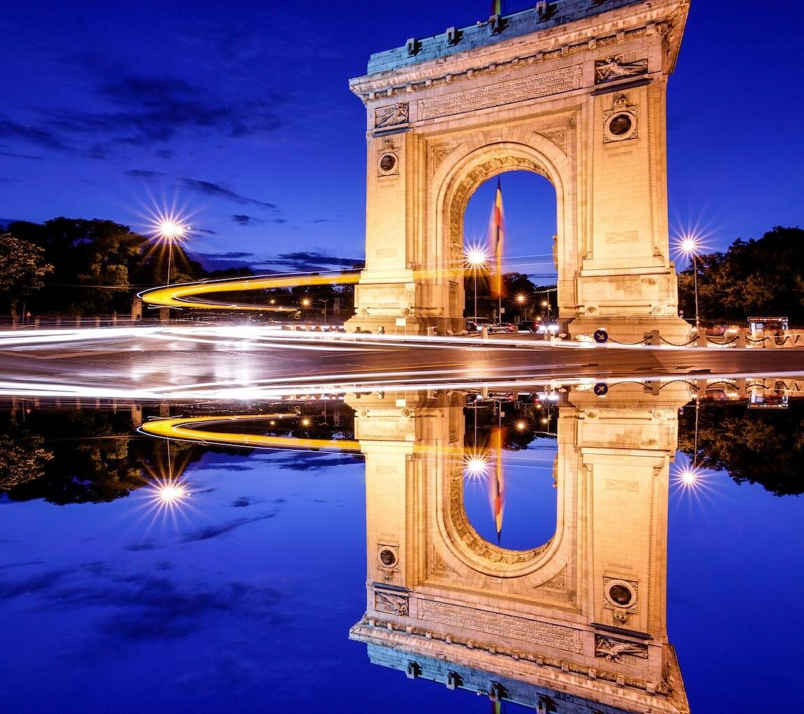 brown concrete arch near body of water during daytime
