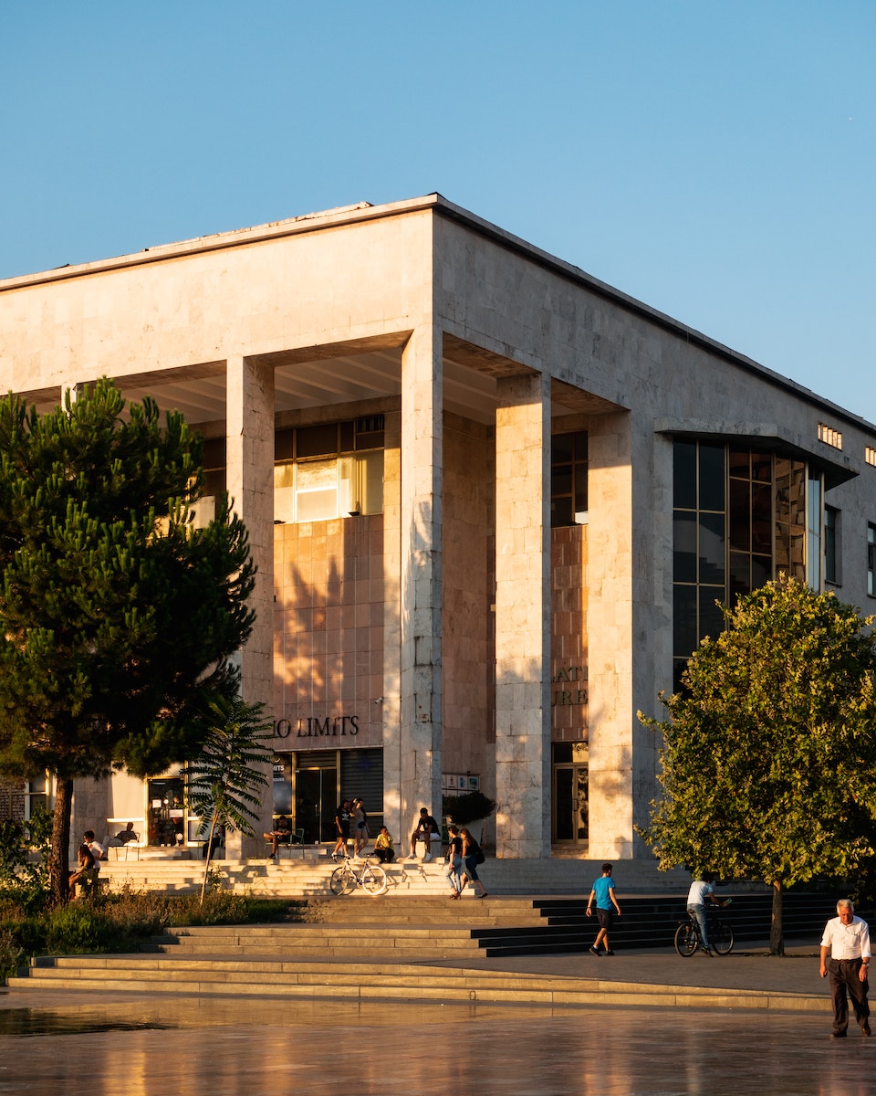 People Sitting on Bench Near Building