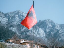 Rocky Mountains and an Albanian Flag in Foreground