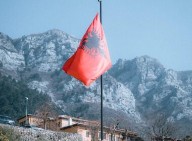 Rocky Mountains and an Albanian Flag in Foreground