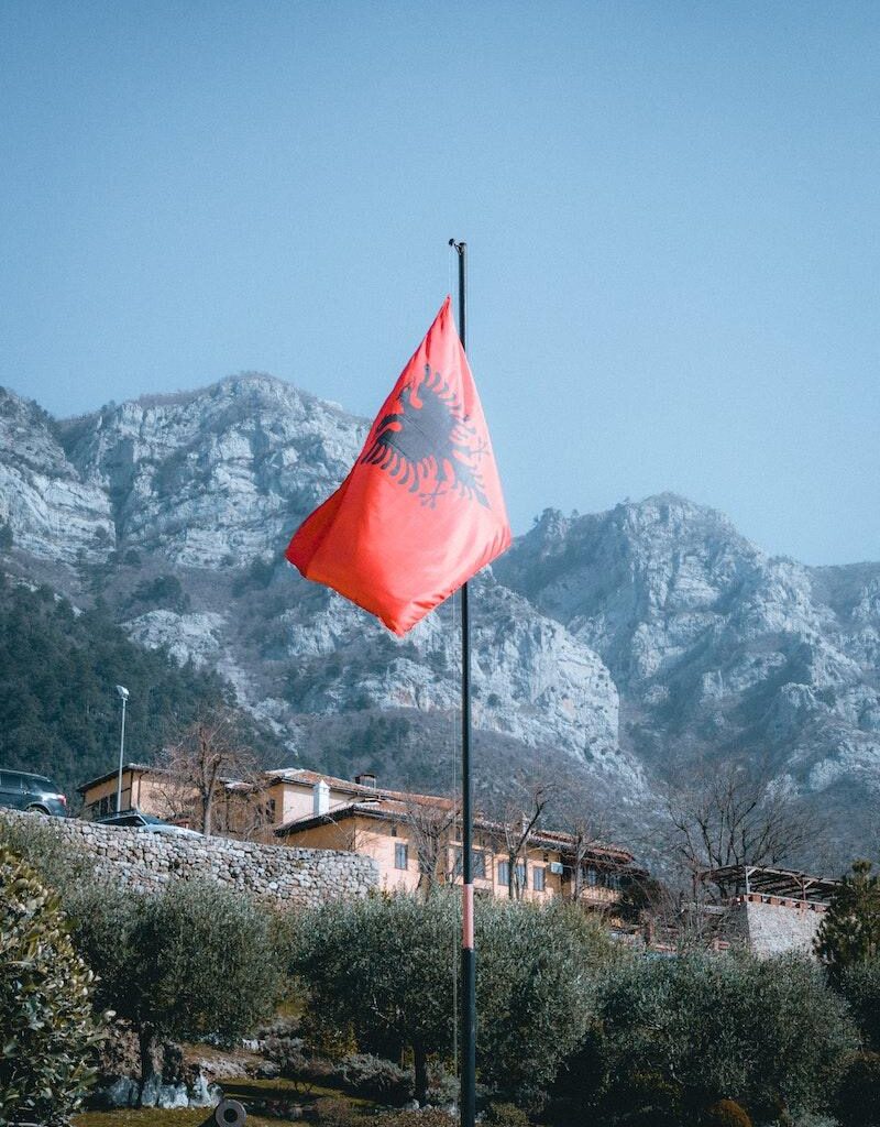 Rocky Mountains and an Albanian Flag in Foreground