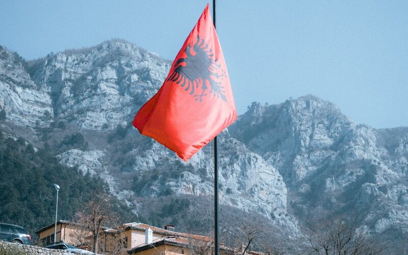 Rocky Mountains and an Albanian Flag in Foreground