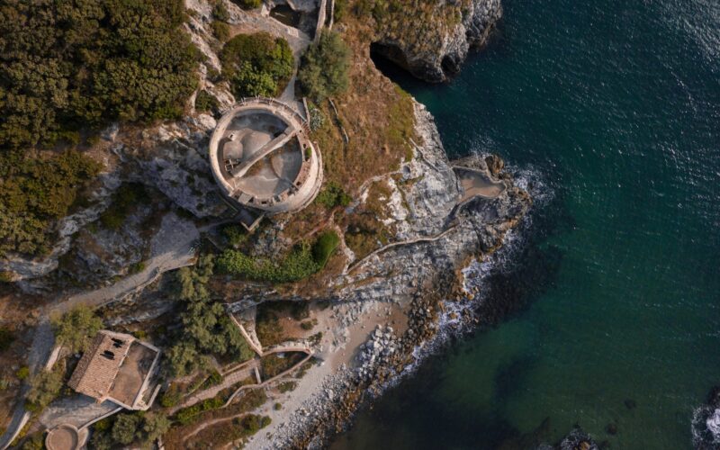 Aerial view of medieval fortress on green seashore