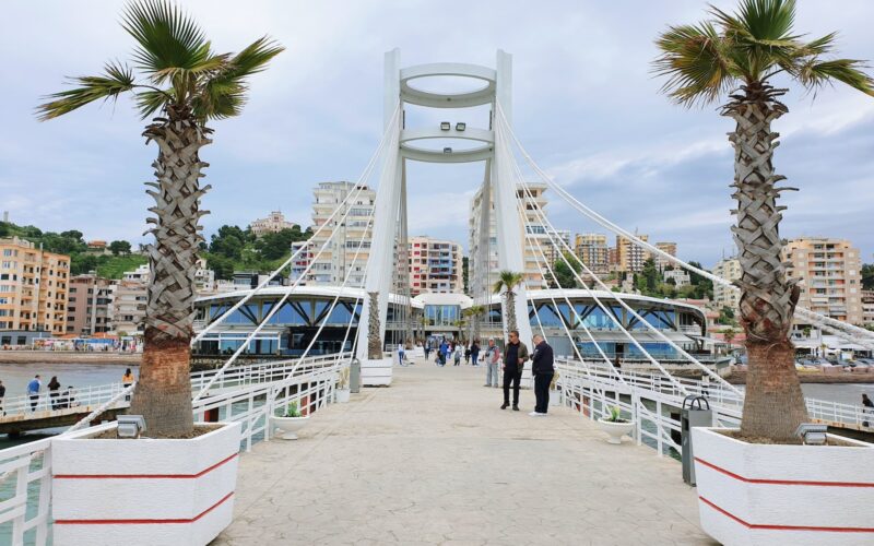 a couple of palm trees sitting on top of a bridge