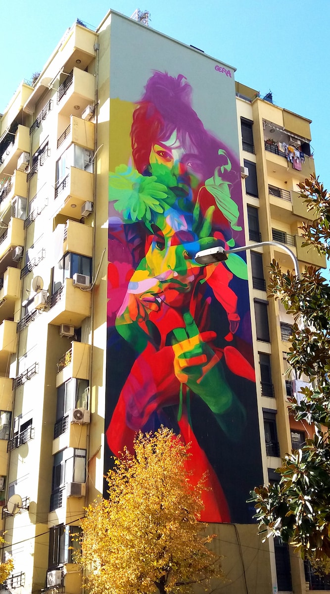 a tall building with a colorful mural on the side of it