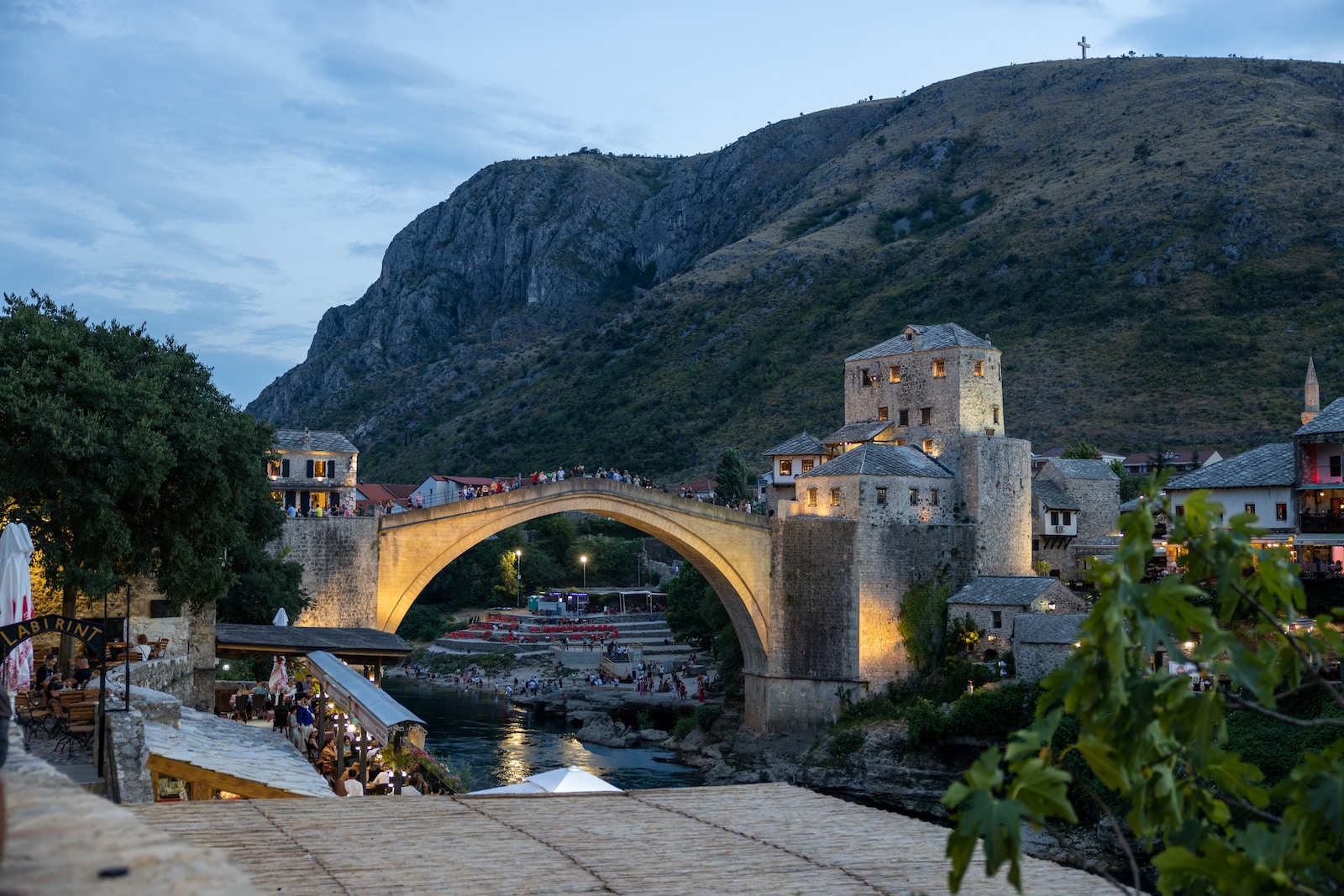 a bridge over a river with a bridge and buildings on the side