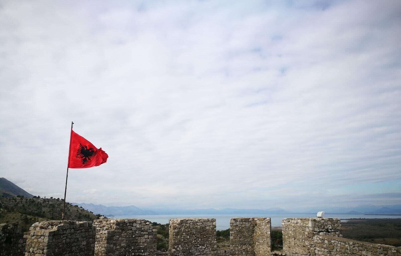 a flag on a stone wall