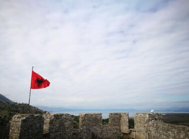 a flag on a stone wall