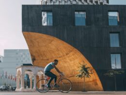 man riding bicycle near building