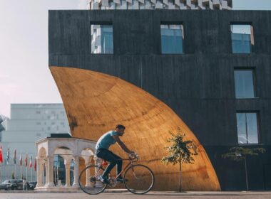 man riding bicycle near building