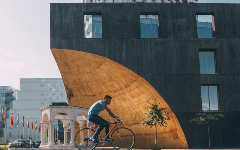 man riding bicycle near building