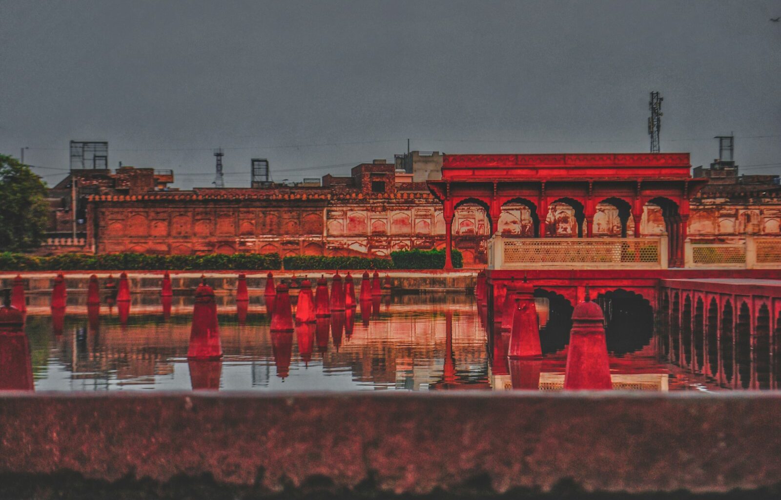red concrete building near body of water during daytime