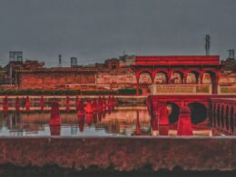 red concrete building near body of water during daytime